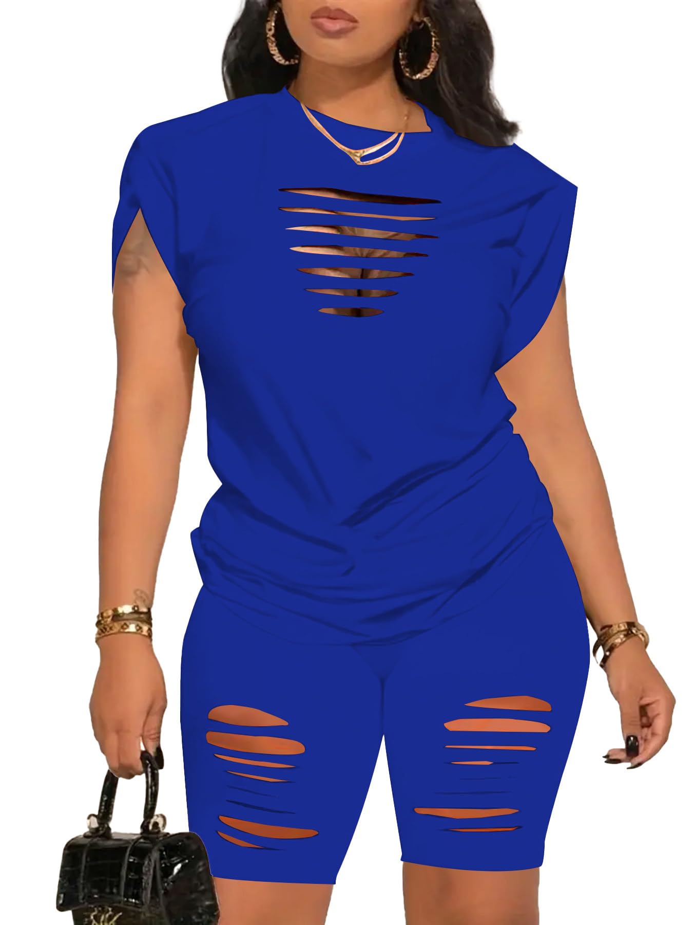 Woman wearing a blue outfit with distressed designs on a white background