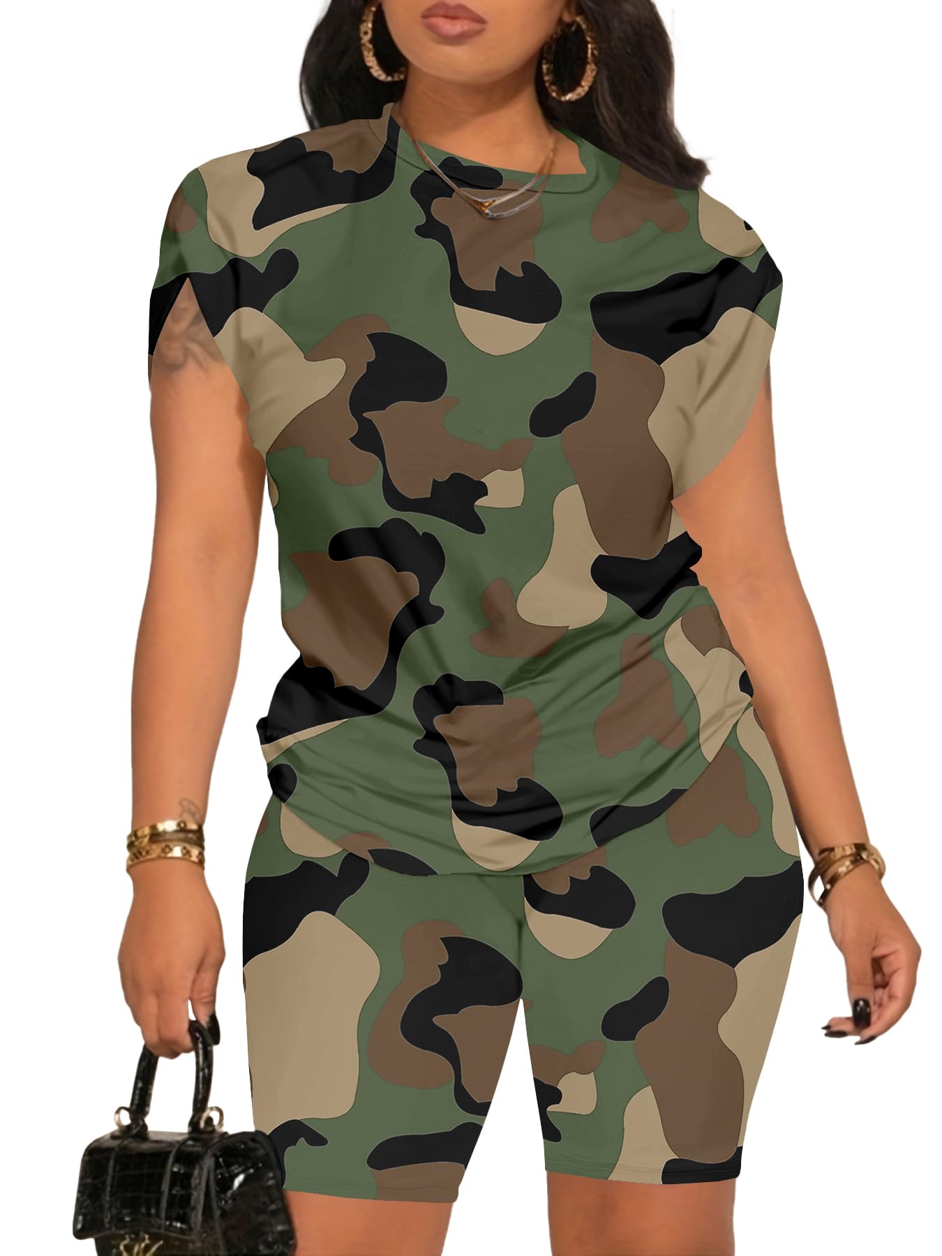 Woman wearing a camouflage outfit with a black handbag on a white background